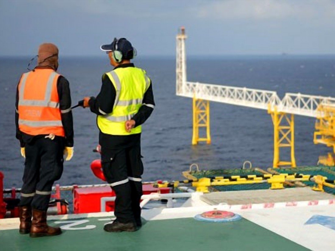 Crew member observing offshore platform operations during a consultancy assignment
